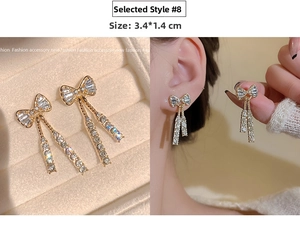Detail view of gold bow tassel earrings with sparkling rhinestones, size 3.4*1.4CM