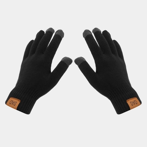 Detail of black knitted gloves with grey touchscreen tips and brown DAD leather label