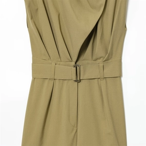 Detail of khakigreen jumpsuit featuring pleated waist and adjustable belt with metal buckle