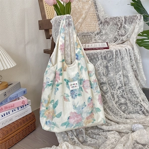 Detailed close-up of floral linen tote bag hanging elegantly on a vintage lace chair