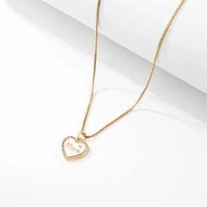 Golden heart necklace with white enamel center and Mama lettering for Mother's Day