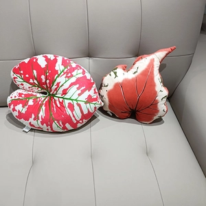 Macro detail of leaf-shaped plush pillows with realistic Caladium plant vein patterns
