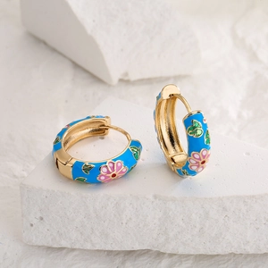 Gold-plated hoop earrings with blue enamel and colorful floral patterns on white stone