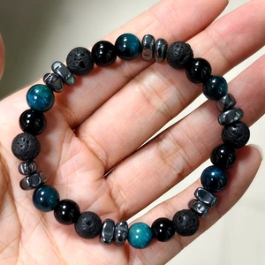 Men's 8mm beaded bracelet featuring tiger eye, lava rock, and hematite on wrist