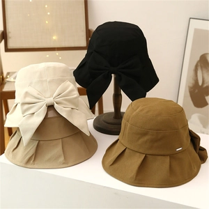 Women's wide brim sun hat with large bow detail in four elegant neutral colors