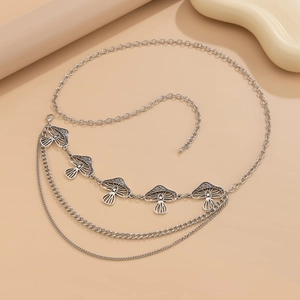 Detail of vintage silver multi-layer waist chain featuring five hollow mushroom charms