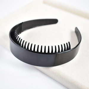 Detail of black plastic headband with teeth for secure non-slip hair styling and facial care