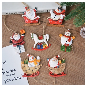 Flat lay of seven Nordic Christmas ornaments including Santa, snowman and rocking horse