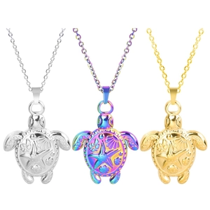 Macro detail of turtle pendants in gold, silver, and rainbow finishes with engraved ocean motifs