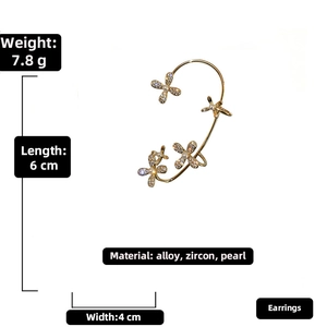 Detail view of 18k gold plated flower ear cuff with pearls and zircons on white background