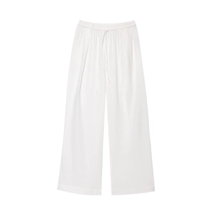 Détail du pantalon large en coton-lin blanc montrant la taille élastique et le cordon