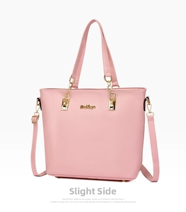 Detail of pink faux leather tote bag with lychee texture and gold metal logo