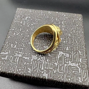 Close-up of golden lion relief carving on vintage titanium steel men's ring band