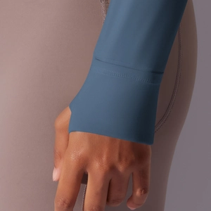 Detailed close-up of thumbhole cuffs on a blue athletic zip-up hooded jacket