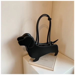 Detail of creative dachshund-shaped black tote bag with matte finish and silver zipper