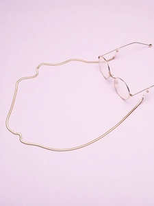 Close-up of gold snake chain eyewear strap with anti-slip loops on purple background