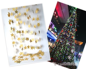 Close-up of golden star garlands and glitter paper banners for festive party decorations