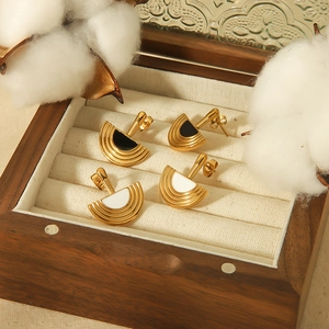 Semicircle gold fan earrings with black and white drip oil inlay in a wooden jewelry box