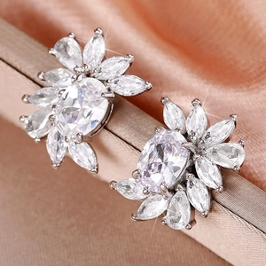Macro view of flower-shaped stud earrings with oval and marquise cubic zirconia