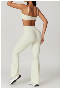 Detail view of beige high-waisted yoga pants and sports bra set with sculpting fit