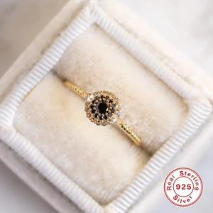 Elegant 925 sterling silver gold plated ring with black halo gemstone in a jewelry box