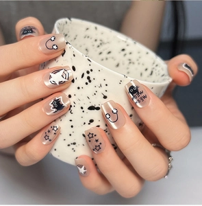 Close-up of sweet cat eye press-on nails featuring cute black cat and star patterns