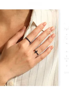 Close-up of S925 sterling silver stacked rings with blue diamonds and cross element