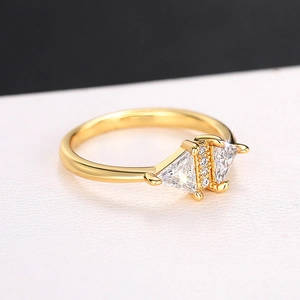 Macro shot of minimalist gold triangle ring with sparkling micro-pave zirconia stones