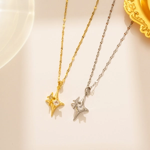 Detailed view of gold and silver four-pointed star cross necklaces with sparkling zircon