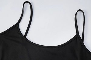 Close-up of thin straps and scoop neckline on a black slim fit maxi dress