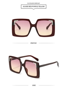 Detail view of square jujube red sunglasses with purple yellow gradient lenses