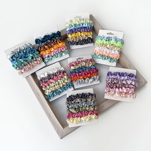 Satin scrunchies set in various colors displayed on white cards in a neat grid