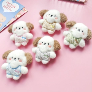 Flat lay of five colorful wool felt puppy pins in brown, pink, green, blue and grey