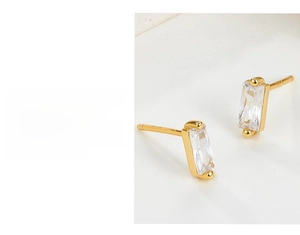 Detailed macro view of S925 sterling silver gold earrings with rectangular zircon stones