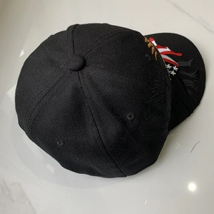 Top view of high-density black cotton baseball cap showing detailed USA flag embroidery