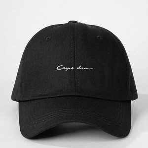 Detailed view of white Carpe Diem embroidery on a black cotton canvas baseball cap