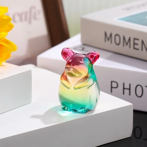 Macro detail of gradient colored crystal glass animal figurine on a white platform