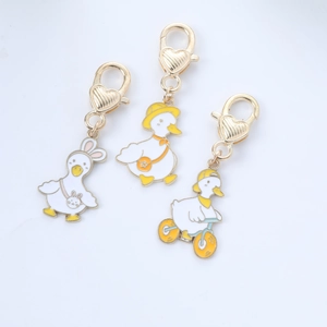 Three cute alloy duck charms with rabbit hat and bicycle details on heart lobster clasps