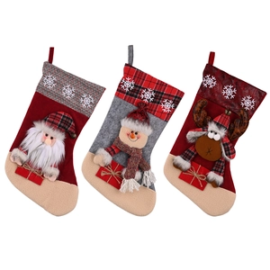 Large Christmas stockings featuring Santa, Snowman, and Reindeer with snowflake patterns