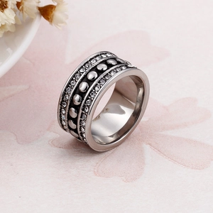 Macro shot of silver vintage wide band ring with crystal pavé and metal bead details