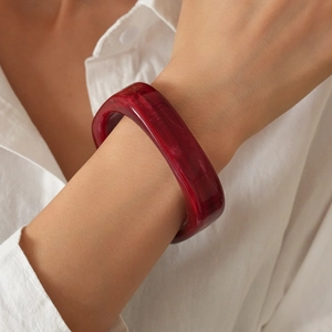 Detailed close-up of red marble texture resin bangle with translucent finish