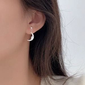 Silver 925 funny moon dangle earrings with face design worn on model's ear