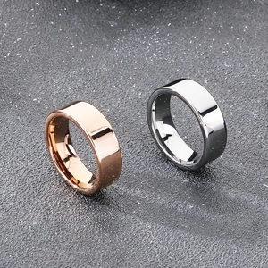 Polished 8mm tungsten steel rings in rose gold and silver on grey textured background