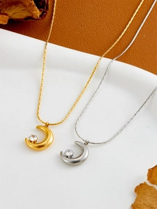 Detail of crescent moon necklace with zircon stone inlay in gold and silver options