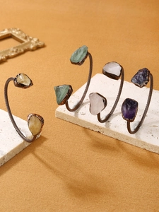 Detailed view of vintage bronze cuff bracelet with irregular natural amethyst crystals
