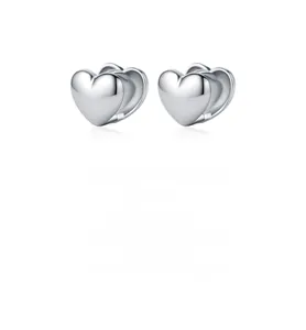 Gros plan de boucles d'oreilles cœur en argent 925 avec surface polie effet miroir