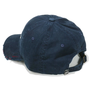 Macro shot of distressed brim and adjustable metal buckle on navy blue baseball cap