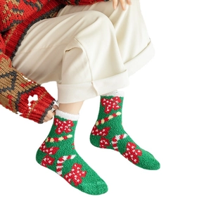 Cozy green Christmas socks with red bows and candy cane patterns in soft coral fleece