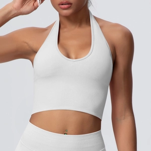 Detail of white ribbed halter yoga bra with deep V-neck and seamless fitness texture