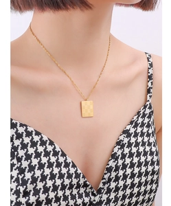 Detail of vintage square checkerboard pendant necklace in gold-plated stainless steel